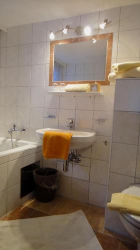 a white bathroom with a sink and a mirror at Pension Elisabeth in Vent