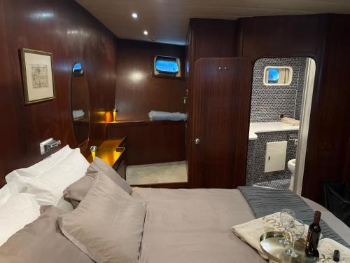 a bedroom with a bed with a table and a mirror at Meridian bleu in Salamina