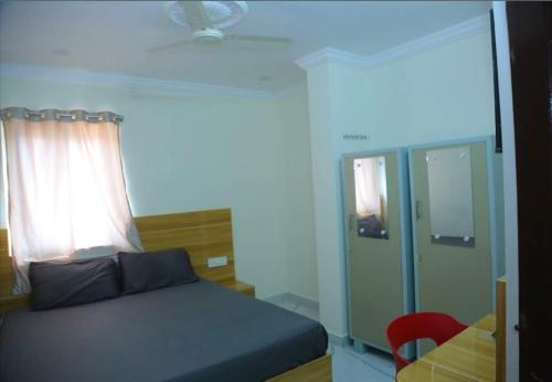 a bedroom with a bed and a window and a desk at Prime PG - Coliving Hostel in Hyderabad