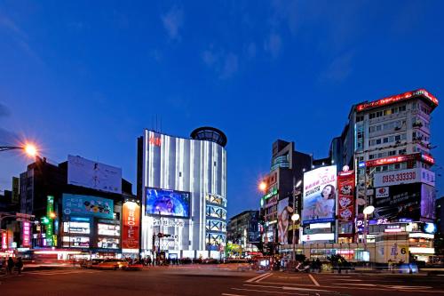 a busy city street at night with buildings at Tomorrow Hotel in Taipei