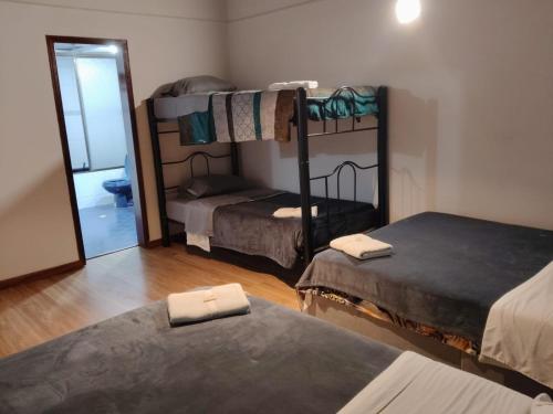 a room with two bunk beds and a mirror at Fortaleza Diosa Chia in Chía