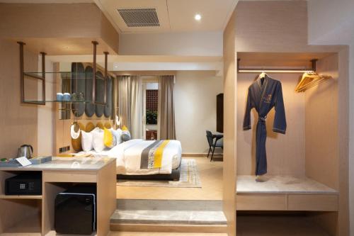 a hotel room with a bed and a desk at The Panache Kautilya in Patna