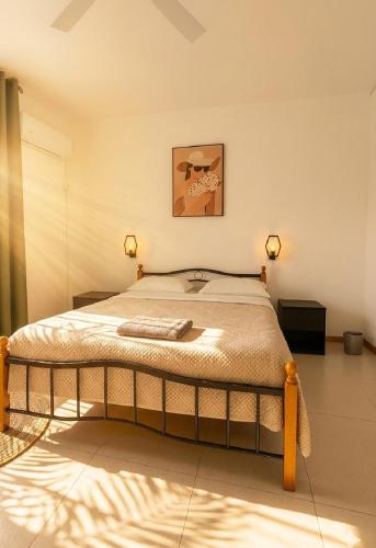 a bedroom with a large bed with two lights on at La Nuit Étoilée , Restez plus, payez moins ! in La Gaulette