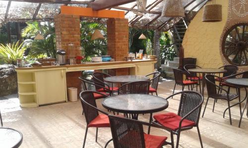 a restaurant with tables and chairs and a bar at RELAX ECO Life Center-Khao Lak in Khao Lak