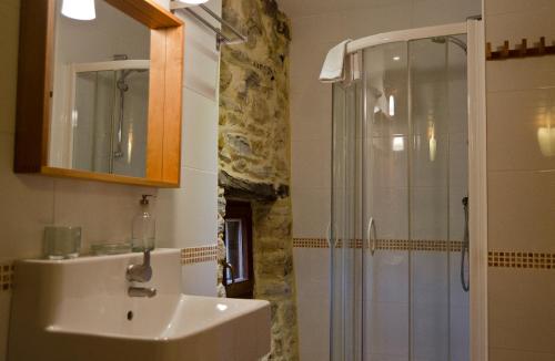 a bathroom with a sink and a shower at Apartamentos Playa Galizano in Galizano