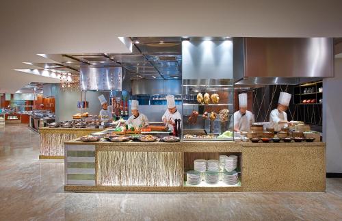 a group of chefs preparing food in a kitchen at Makati Shangri-La, Manila in Manila