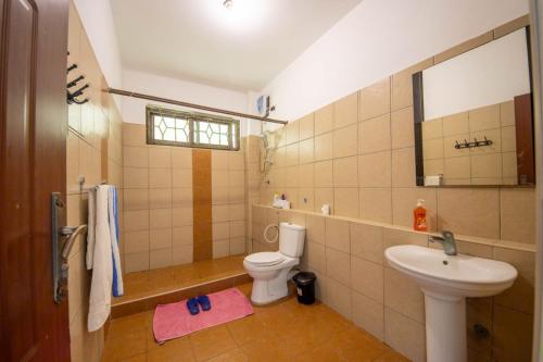 a bathroom with a toilet and a sink at Bamburi Mombasa two bedroom Cutraz homes apartments with swimming pool 005 in Mtwapa