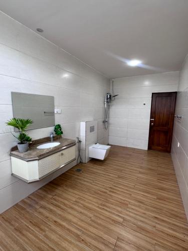 a bathroom with a sink and a toilet in a room at Ruish City Kandy in Kandy