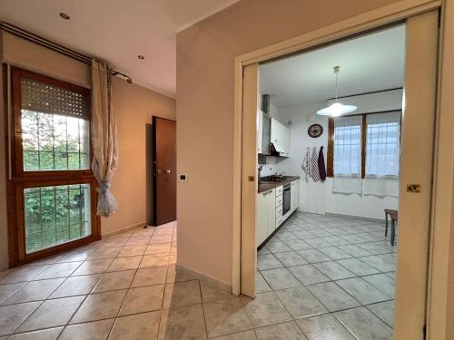 a kitchen with a door open to a dining room at La casetta in Pontedera