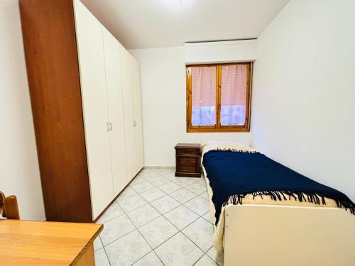 a bedroom with a bed and a table and a window at La casetta in Pontedera