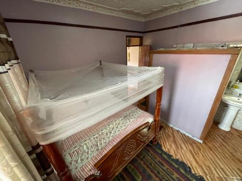 an empty bed in a room with a toilet at APARTMENT 01 Meadowbrook Home Stade in Kasaayi