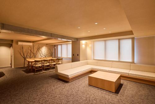 a living room with a couch and a table at 開土 KAIDO Hotel in Sapporo