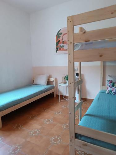 a room with two bunk beds and a table at Maison écologique avec piscine in La Puerta de Segura