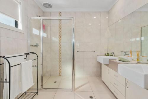 a bathroom with a shower and a sink at The Lake House in Mulwala