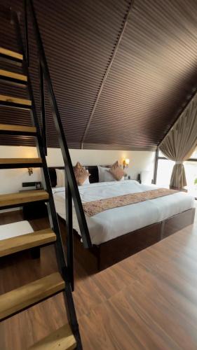 a bedroom with a bed with a wooden floor at THE RiYASAT SARISKA in Ajabgarh