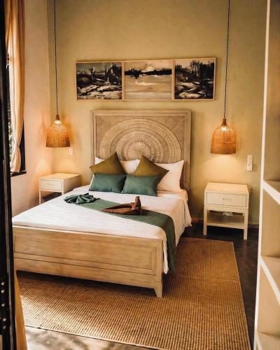 a bedroom with a bed with a dog laying on it at Art Hill Villas in Kao Kuil