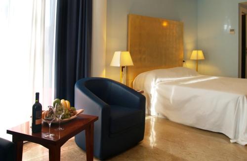 a hotel room with a chair and a bed at Hotel Terme Marine Leopoldo II TERME & SPA in Marina di Grosseto