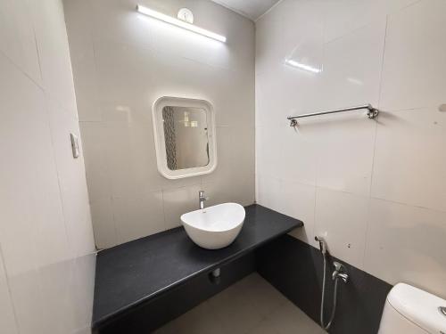a bathroom with a bowl sink on a black counter at RnB Beach Resort in Anjuna