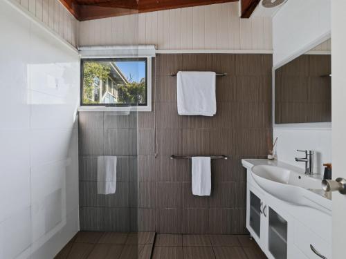 a bathroom with a sink and a mirror at Prom Coast Oasis - Sandy Point in Sandy Point