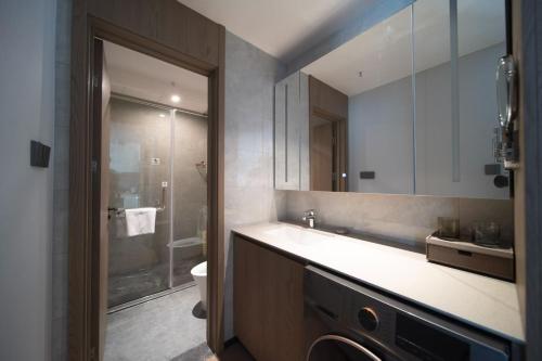 a bathroom with a sink and a toilet and a shower at Citadines Luyang Hefei in Hefei