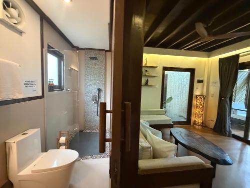 a bathroom with a toilet and a sink at JungleNest Resort in General Luna
