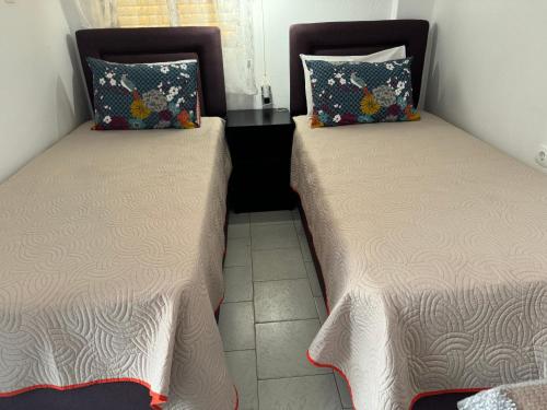 two beds sitting next to each other in a room at Sofia Rooms in Palaiochora