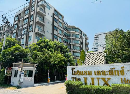 a sign in front of a tall building at The Lux Ladprao 10 in Bangkok