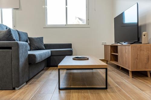 a living room with a couch and a coffee table at Feeling Doñana in Villamanrique de la Condesa