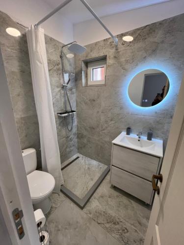 a bathroom with a toilet and a sink and a mirror at Domeniul La Mosie in Slimnic