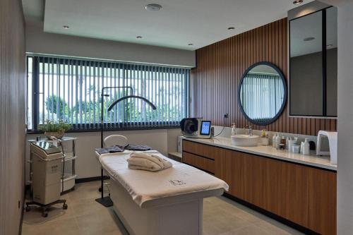 a bathroom with a sink and a mirror at De Suite Hotel in Antalya