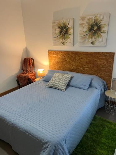 a bedroom with a bed with a blue comforter at Mountain and Sea in Ribeira Grande