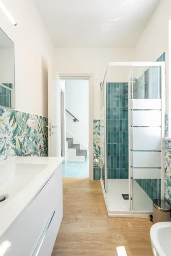 a bathroom with a glass shower and a staircase at La casa del Pescatore in Procida