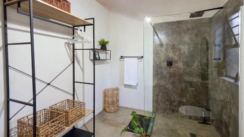 a bathroom with a shower and a glass door at Khaya Kwalata in Marloth Park