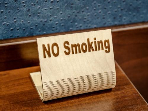 a no smoking sign sitting on top of a table at Road Star Hotel in Dnipro