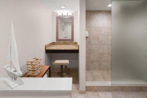 a bathroom with a sink and a shower at Days Hotel by Wyndham Toms River Jersey Shore in Toms River