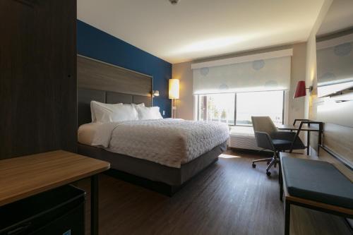 a hotel room with a bed and a desk at Tru By Hilton Hazleton in Hazleton