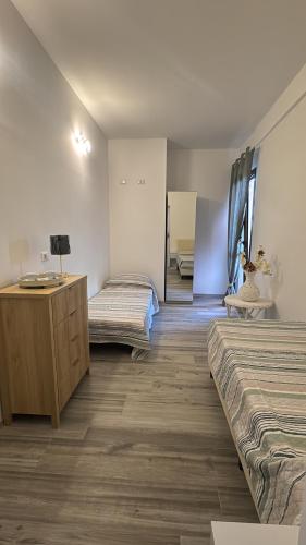 a room with two beds and a desk and a mirror at La Cupoletta -Holiday House - GILDA in Trevignano Romano