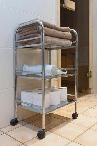 a rolling towel rack with towels and towels at Jõe Apartments - apartments with sauna in the city center in Tallinn