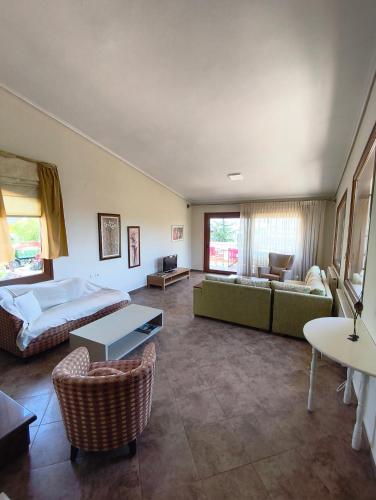 a bedroom with a bed and a couch and a table at Palio Dream House in Paleo Tsifliki