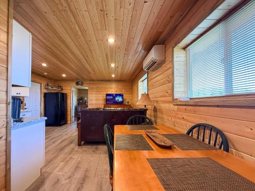 a kitchen and dining room with a table and chairs at Cozy Pine Getaway in Sequim
