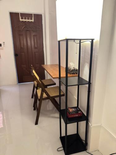 a room with a table and a chair and a door at Spacious Bunk Bed & Dedicated Workspace in Baler