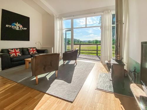 a living room with a couch and a table at Yew Tree Barn - Hw7737 in Usk