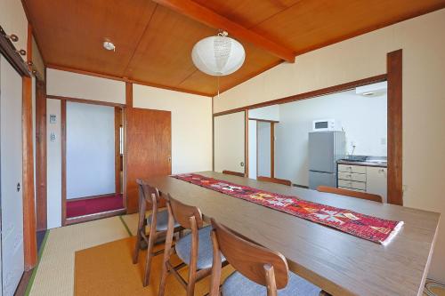 a dining room with a long wooden table and chairs at Authentic Local Experience House in Nara