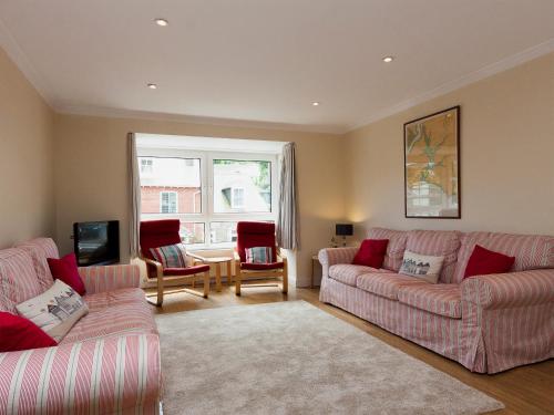 a living room with two couches and a television at Oakridge in Salcombe