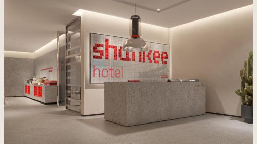 a lobby with a reception desk and a cactus at SHANKEE Hotel Melawai Blok M Jakarta in Jakarta