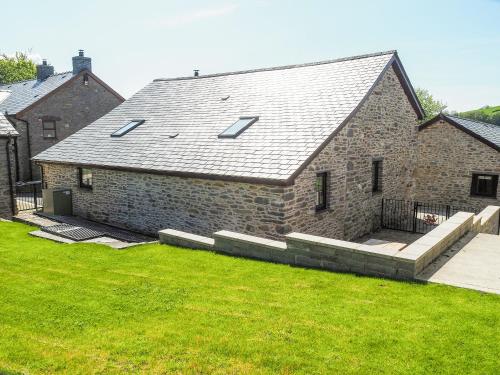a large brick house with a grass yard at Ty Gwair - Uk41512 in Lampeter