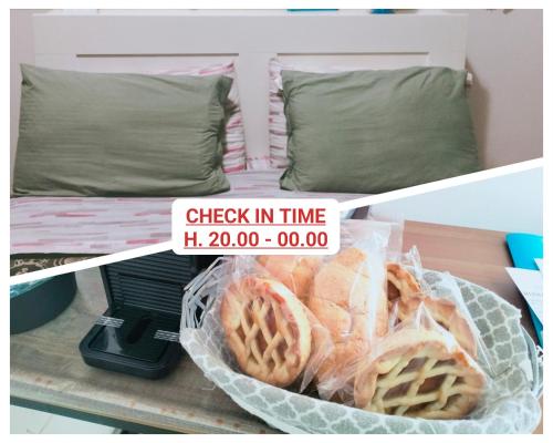 a basket of bread on a shelf with a bed at La Perla B & B CHECK IN TIME DA FROM H 20 PM in Ciampino