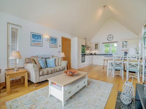 a living room with a couch and a table at Twill Lodge - 4 Swandown in Cudworth