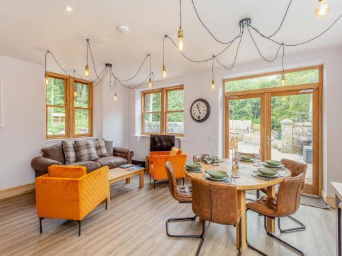a living room with a table and chairs at Gardeners Cottage in Huntly