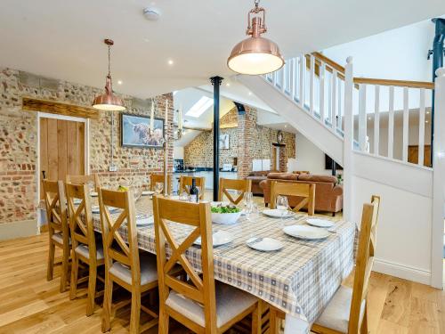 a dining room with a table and chairs at Pipistrelle Barn in North Walsham